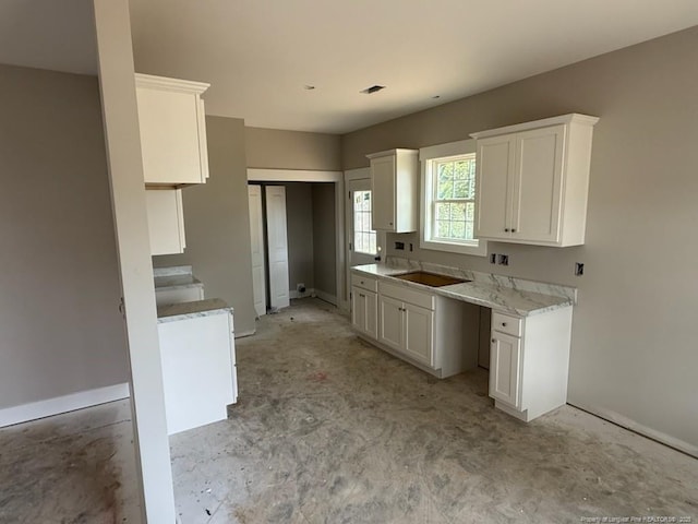 707 N Wilson Ave, Dunn, NC 28334 - kitchen with white cabinetry and light countertops