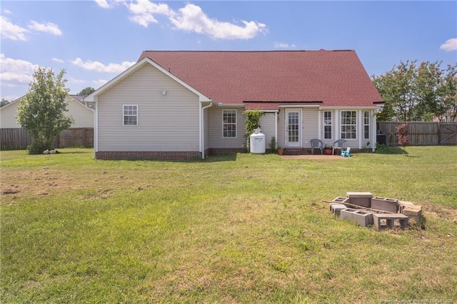 109 Hayes Ct, Raeford, NC 28376 - back of house with a fenced backyard, a patio area, and a shingled roof
