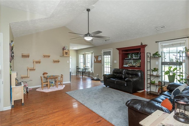 109 Hayes Ct, Raeford, NC 28376 - living room featuring a textured ceiling, ceiling fan, plenty of natural light, wood finished floors, and lofted ceiling