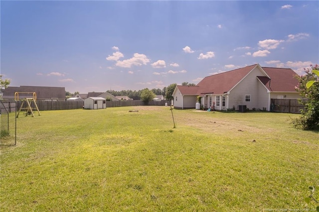 109 Hayes Ct, Raeford, NC 28376 - fenced backyard featuring a storage shed, a playground, and an attached garage