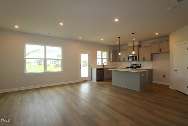 1218 Tredenham Way, Durham, NC 27703 - kitchen featuring stainless steel appliances, dark wood-type flooring, a kitchen island, light countertops, and decorative backsplash