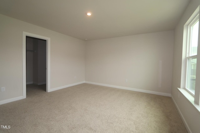 1218 Tredenham Way, Durham, NC 27703 - unfurnished bedroom with carpet flooring, a spacious closet, and recessed lighting