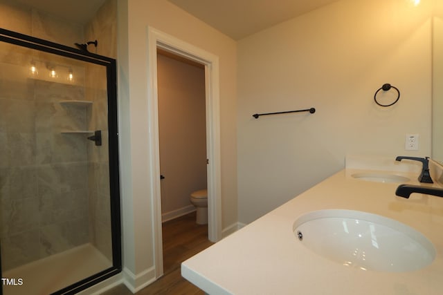 1218 Tredenham Way, Durham, NC 27703 - bathroom with a stall shower, double vanity, and wood finished floors