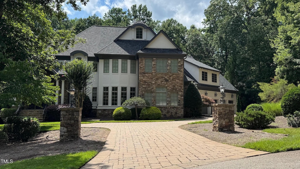6033 Over Hadden Ct, Raleigh, NC 27614 - french country home featuring stucco siding, stone siding, and curved driveway