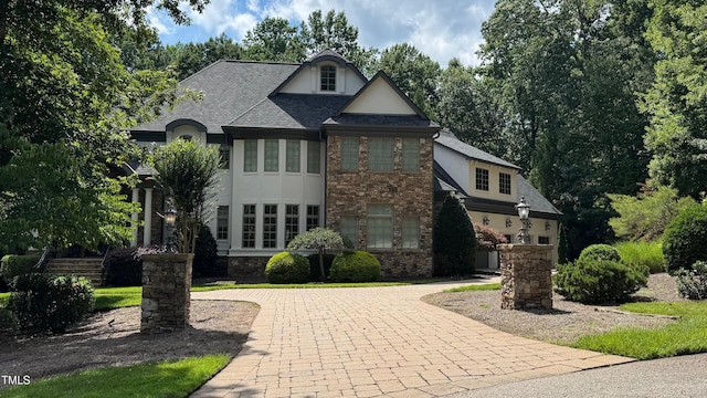 6033 Over Hadden Ct, Raleigh, NC 27614 - french country home featuring stucco siding, stone siding, and curved driveway