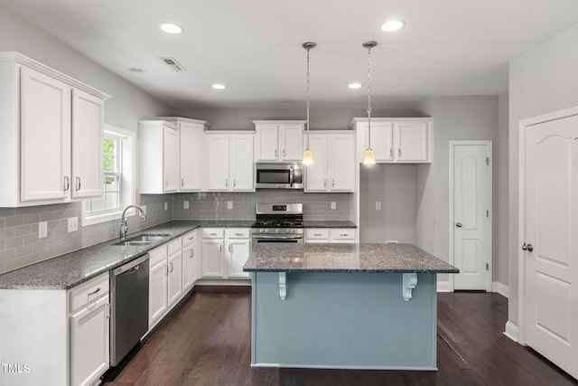 3401 Grosbeak Way, Raleigh, NC 27616 - kitchen featuring stainless steel appliances, white cabinets, backsplash, dark stone counters, and recessed lighting