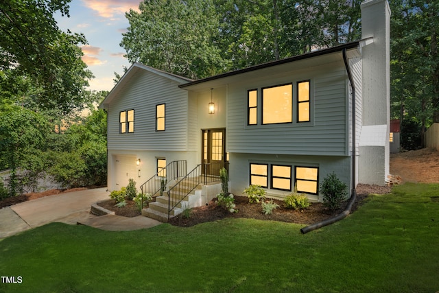 4349 Pickwick Dr, Raleigh, NC 27613 - split foyer home featuring driveway, a chimney, a lawn, and a garage