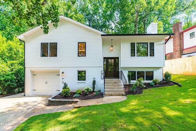 4349 Pickwick Dr, Raleigh, NC 27613 - raised ranch featuring a garage, driveway, and a chimney