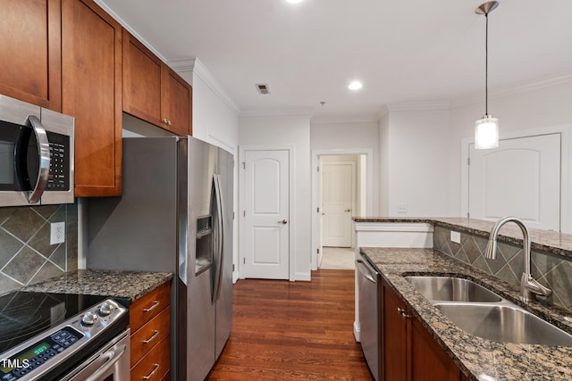7250 NC-751 Hwy Unit 2204, Durham, NC 27707 - kitchen featuring stainless steel appliances, dark wood finished floors, ornamental molding, brown cabinetry, and decorative backsplash