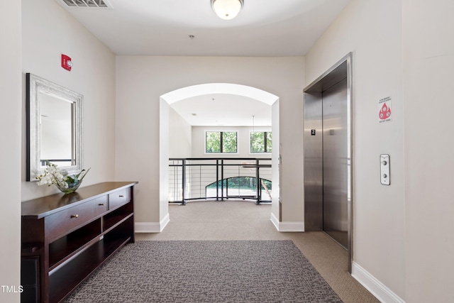 7250 NC-751 Hwy Unit 2204, Durham, NC 27707 - hall with elevator, carpet flooring, and arched walkways