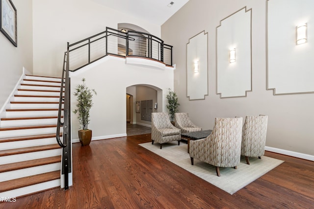 7250 NC-751 Hwy Unit 2204, Durham, NC 27707 - sitting room with arched walkways, wood finished floors, a high ceiling, and stairs