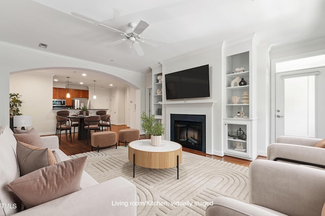 7250 NC-751 Hwy Unit 2204, Durham, NC 27707 - living room featuring arched walkways, light wood-type flooring, ceiling fan, ornamental molding, and recessed lighting