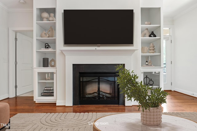 7250 NC-751 Hwy Unit 2204, Durham, NC 27707 - living area featuring ornamental molding, wood finished floors, built in features, and a glass covered fireplace