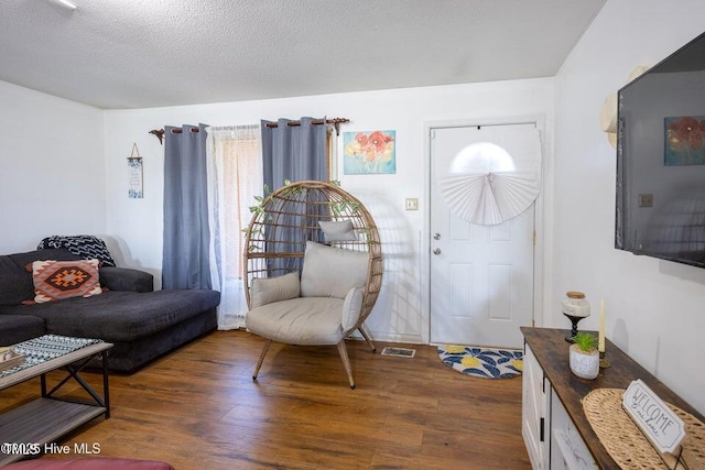 800 S Vance St, Fremont, NC 27830 - living area with wood finished floors and a textured ceiling