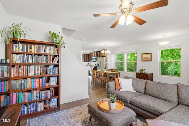 534 Hobkirks Pl, Durham, NC 27704 - living room with wood finished floors, a ceiling fan, and a chandelier
