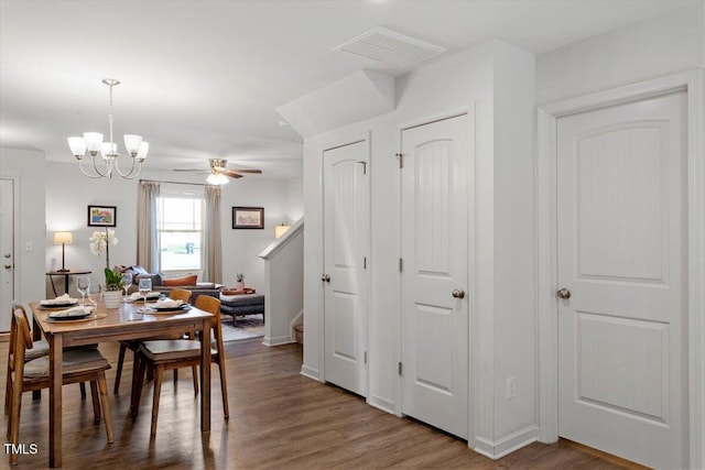 534 Hobkirks Pl, Durham, NC 27704 - dining room featuring a ceiling fan, wood finished floors, stairway, and a chandelier