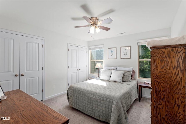 534 Hobkirks Pl, Durham, NC 27704 - bedroom with two closets, light colored carpet, and ceiling fan