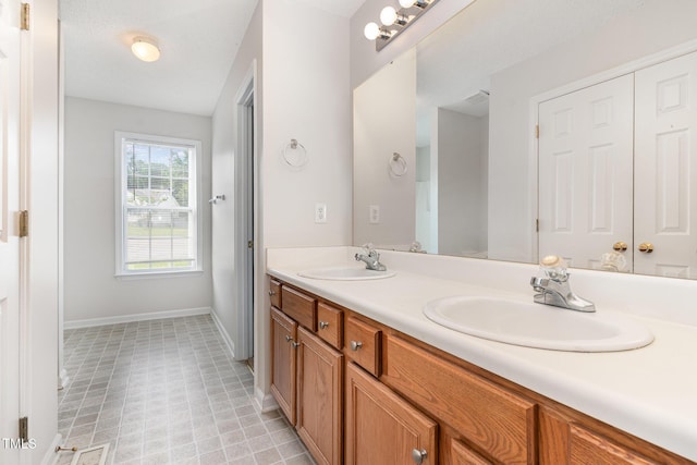 432 Barn View Ct, Fuquay Varina, NC 27526 - bathroom featuring double vanity and baseboards