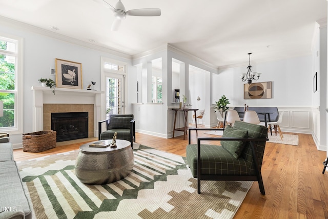 204 Towne Ridge Ln, Chapel Hill, NC 27516 - living room with healthy amount of natural light, light wood finished floors, ceiling fan, crown molding, and a fireplace