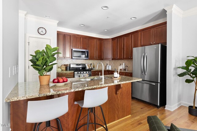 204 Towne Ridge Ln, Chapel Hill, NC 27516 - kitchen featuring stainless steel appliances, tasteful backsplash, a kitchen bar, light stone counters, and crown molding
