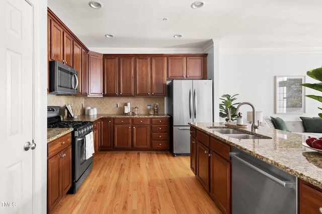 204 Towne Ridge Ln, Chapel Hill, NC 27516 - kitchen with stainless steel appliances, crown molding, light stone countertops, light wood finished floors, and tasteful backsplash