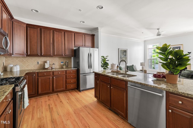 204 Towne Ridge Ln, Chapel Hill, NC 27516 - kitchen with appliances with stainless steel finishes, ornamental molding, light wood finished floors, decorative backsplash, and light stone countertops