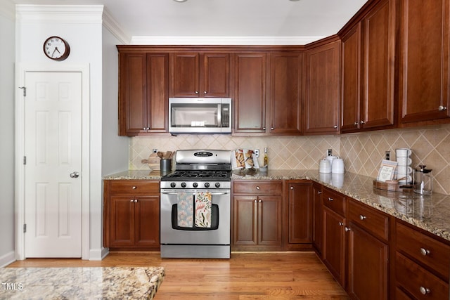 204 Towne Ridge Ln, Chapel Hill, NC 27516 - kitchen featuring appliances with stainless steel finishes, light wood-style floors, tasteful backsplash, and stone countertops