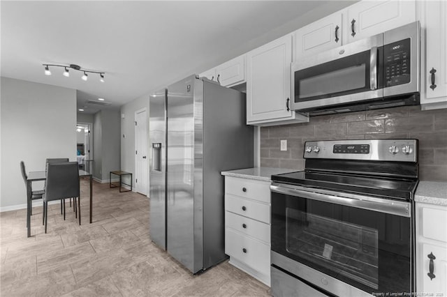 1921 Yellowbrick Rd, Fayetteville, NC 28314 - kitchen with appliances with stainless steel finishes, backsplash, and white cabinets