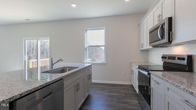 170 Babbling Creek Dr, Youngsville, NC 27596 - kitchen with appliances with stainless steel finishes, dark wood-style flooring, light stone countertops, tasteful backsplash, and recessed lighting