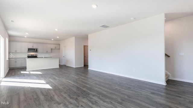 170 Babbling Creek Dr, Youngsville, NC 27596 - unfurnished living room featuring dark wood-style floors, recessed lighting, and stairs