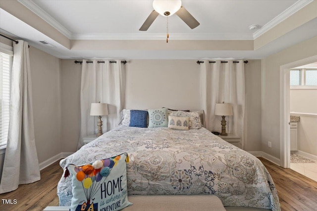 824 Stanly House St, Wake Forest, NC 27587 - bedroom featuring wood finished floors, crown molding, a tray ceiling, ceiling fan, and connected bathroom