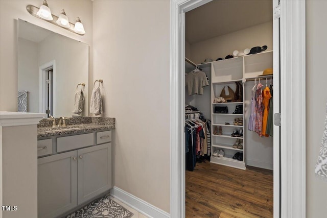 824 Stanly House St, Wake Forest, NC 27587 - bathroom featuring vanity, wood finished floors, and a walk in closet
