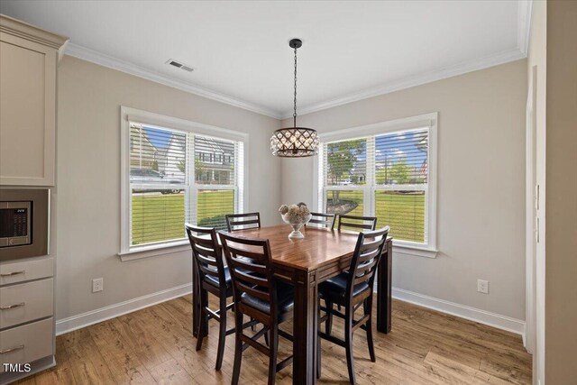 824 Stanly House St, Wake Forest, NC 27587 - dining room featuring light wood finished floors, ornamental molding, and a chandelier