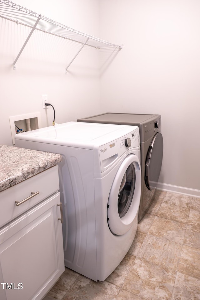 1402 Southpoint Trl, Durham, NC 27713 - washroom with washing machine and dryer and light stone finish floors