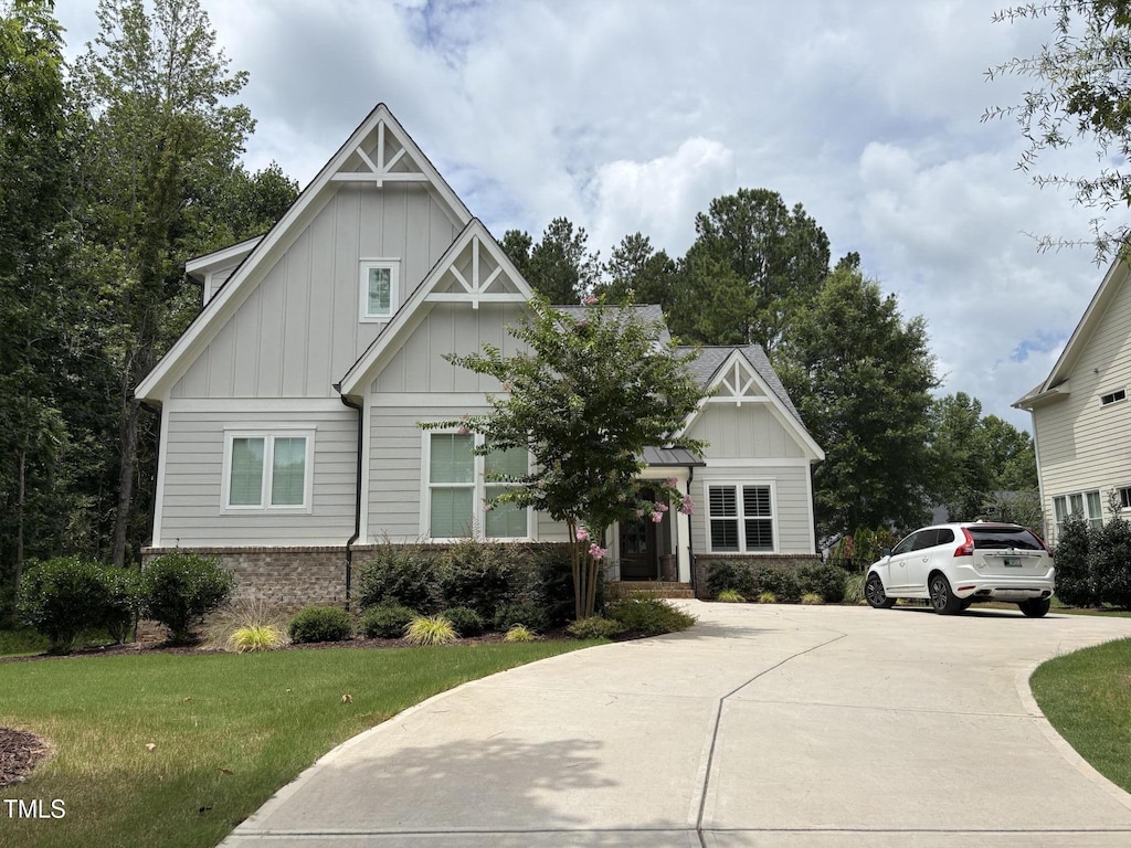 961 Cabin Crk, Pittsboro, NC 27312 - craftsman inspired home with board and batten siding, concrete driveway, brick siding, and a front lawn