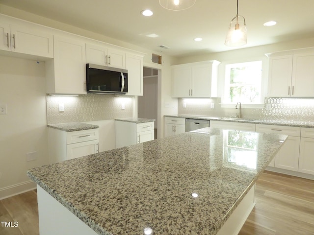 5610 Plain View Highway, Dunn, NC 28334 - kitchen with appliances with stainless steel finishes, light wood finished floors, light stone countertops, and recessed lighting