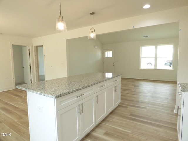 5610 Plain View Highway, Dunn, NC 28334 - kitchen with white cabinets, light wood finished floors, pendant lighting, a center island, and open floor plan