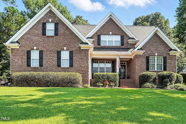 164 Avocet Ln, Clayton, NC 27520 - view of front facade featuring a front lawn, brick siding, and a shingled roof