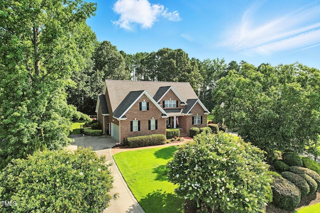 164 Avocet Ln, Clayton, NC 27520 - view of front of home with brick siding, driveway, an attached garage, and a front lawn