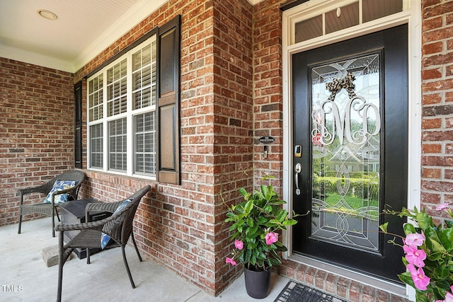 164 Avocet Ln, Clayton, NC 27520 - doorway to property featuring covered porch and brick siding