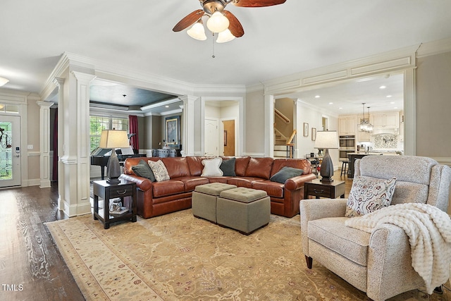 164 Avocet Ln, Clayton, NC 27520 - living room featuring decorative columns, stairs, ceiling fan, crown molding, and wood finished floors