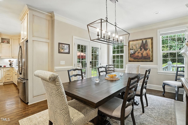 164 Avocet Ln, Clayton, NC 27520 - dining area featuring french doors, ornamental molding, dark wood-type flooring, and a chandelier