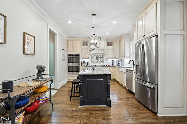 164 Avocet Ln, Clayton, NC 27520 - kitchen featuring stainless steel appliances, a center island, cream cabinetry, backsplash, and crown molding