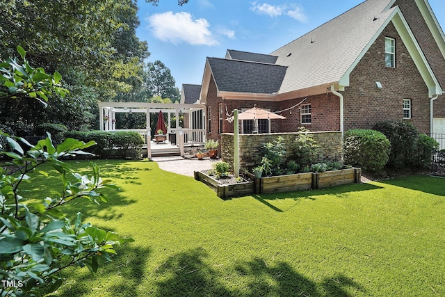 164 Avocet Ln, Clayton, NC 27520 - rear view of property featuring a vegetable garden, roof with shingles, brick siding, a pergola, and a wooden deck