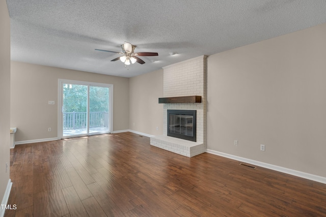 4140 Willow Haven Ct, Raleigh, NC 27616 - unfurnished living room featuring ceiling fan, dark wood finished floors, a fireplace, and a textured ceiling