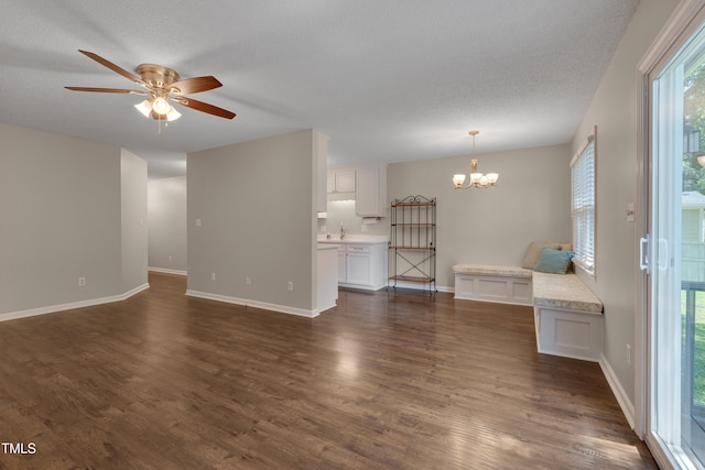 4140 Willow Haven Ct, Raleigh, NC 27616 - unfurnished living room featuring a chandelier, dark wood-style floors, ceiling fan, and a textured ceiling