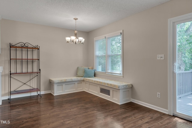 4140 Willow Haven Ct, Raleigh, NC 27616 - unfurnished dining area with dark wood finished floors, a chandelier, and a textured ceiling