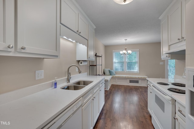 4140 Willow Haven Ct, Raleigh, NC 27616 - kitchen featuring white appliances, a chandelier, white cabinets, dark wood-style flooring, and decorative light fixtures