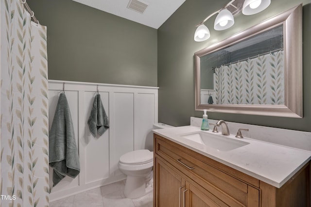 4140 Willow Haven Ct, Raleigh, NC 27616 - bathroom featuring vanity, tile patterned floors, and a wainscoted wall