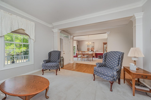 302 Caraway Ln, Cary, NC 27519 - living area featuring decorative columns, crown molding, a chandelier, and carpet flooring